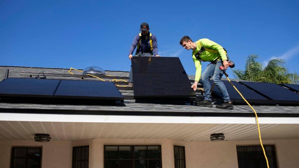 Two men starting on a solar panel installation.
