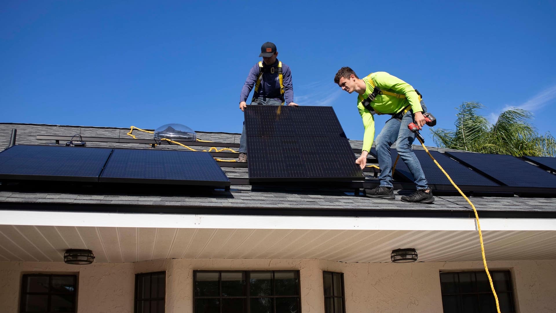 Two men starting on a solar panel installation.